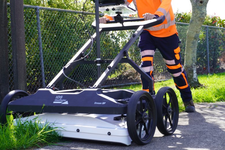 Ground penetrating radar machine being pushed by operator