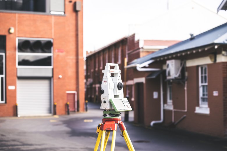 Theodolite on tripod in housing courtyard