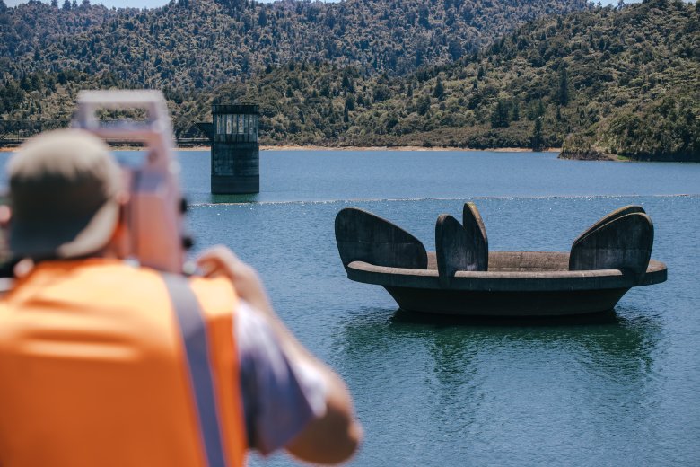 Surveyor surveying at Waitakere dam