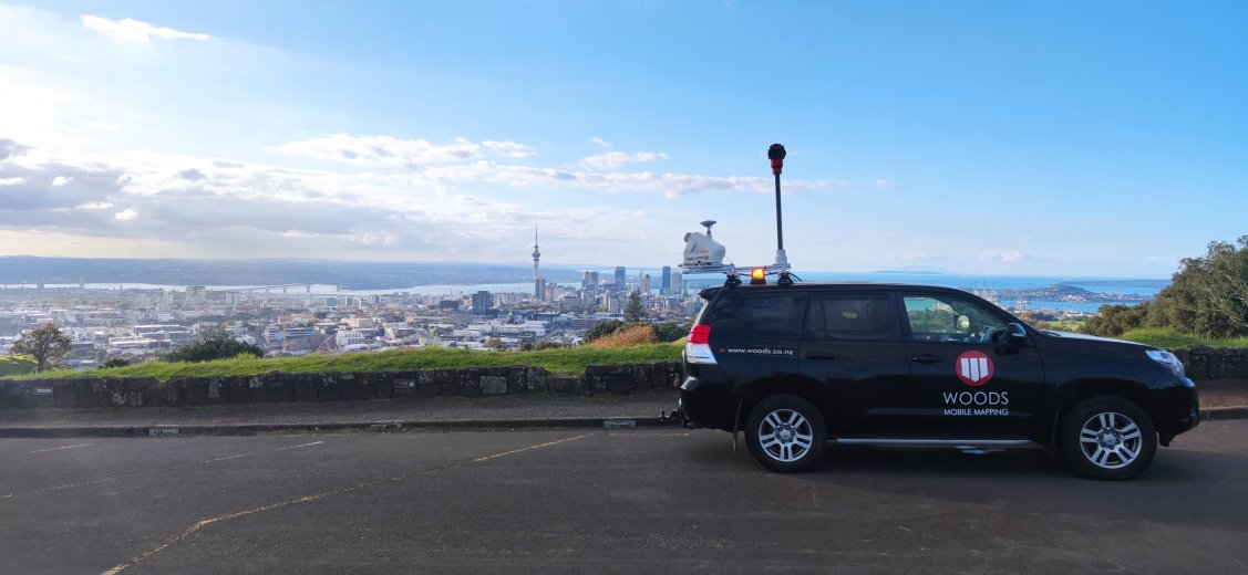 Geospatial Woods truck on Auckland mountain with city view in background