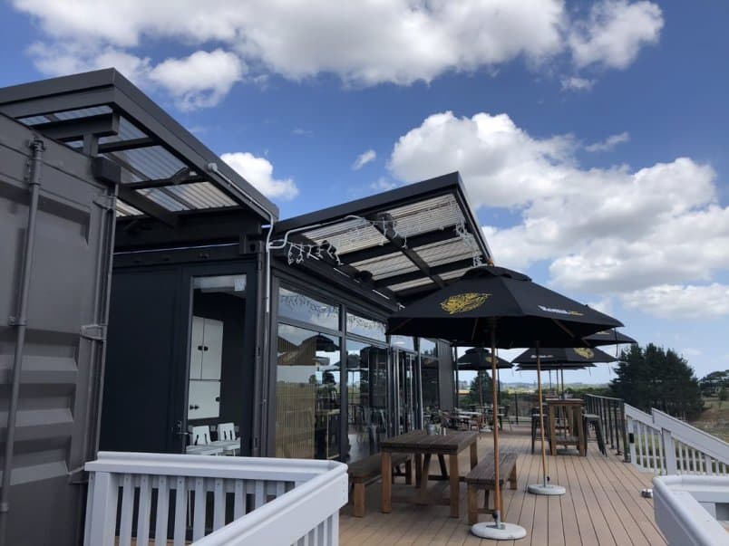 Image of cafe showing tables and chairs outside