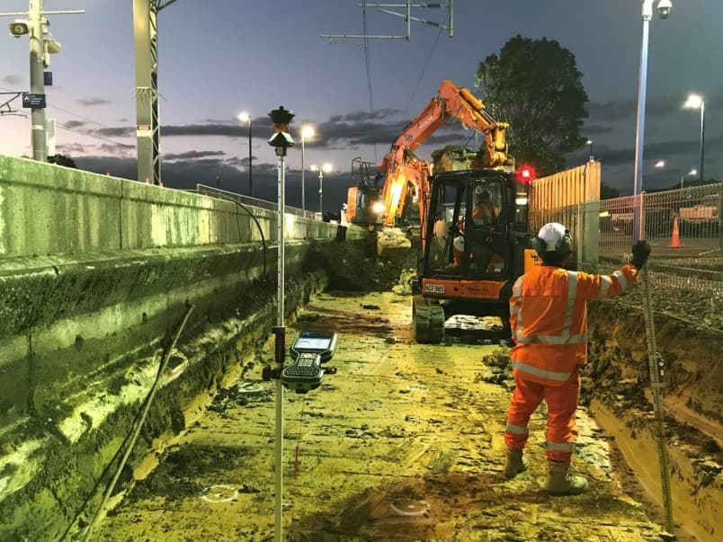 Image of survey equipment on street at night