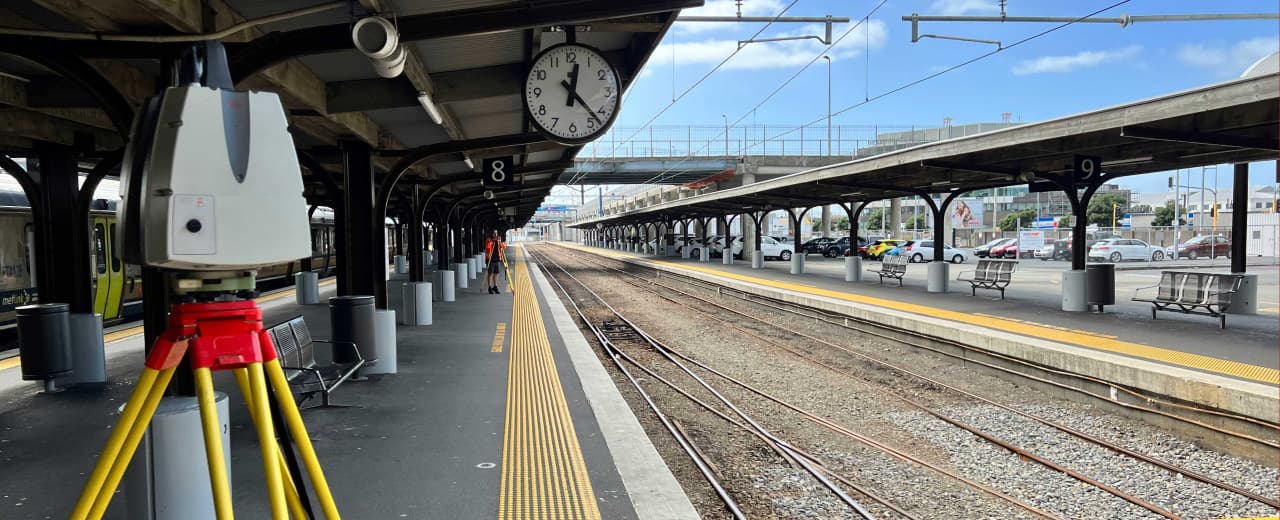 Image of surveying device on a tripod on a train station platform