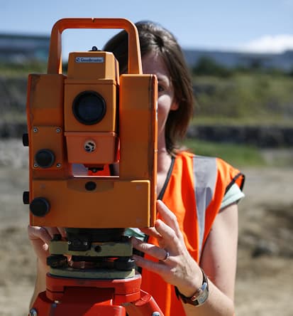 Image of surveyor using survey equipment