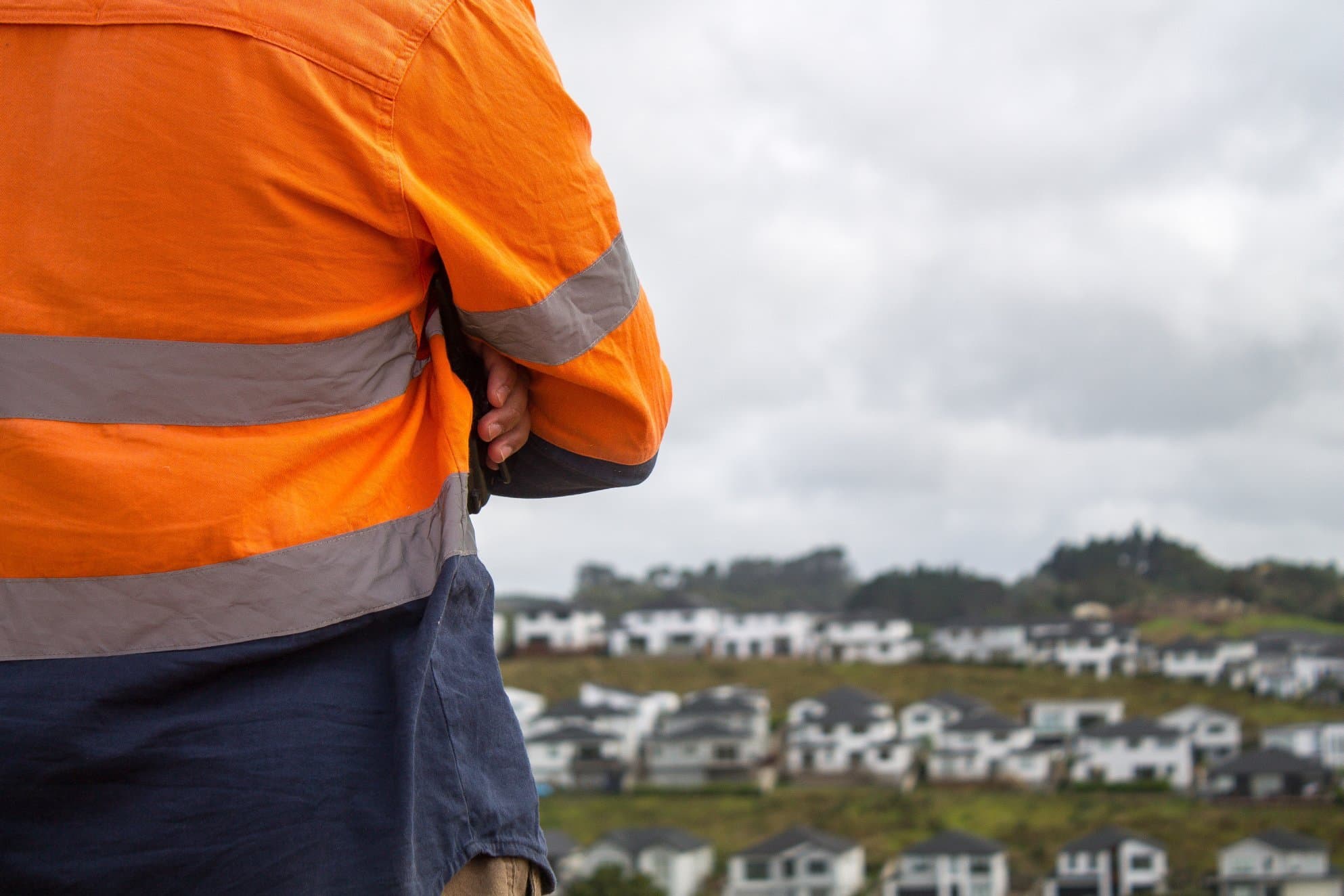 Worker looking out at development